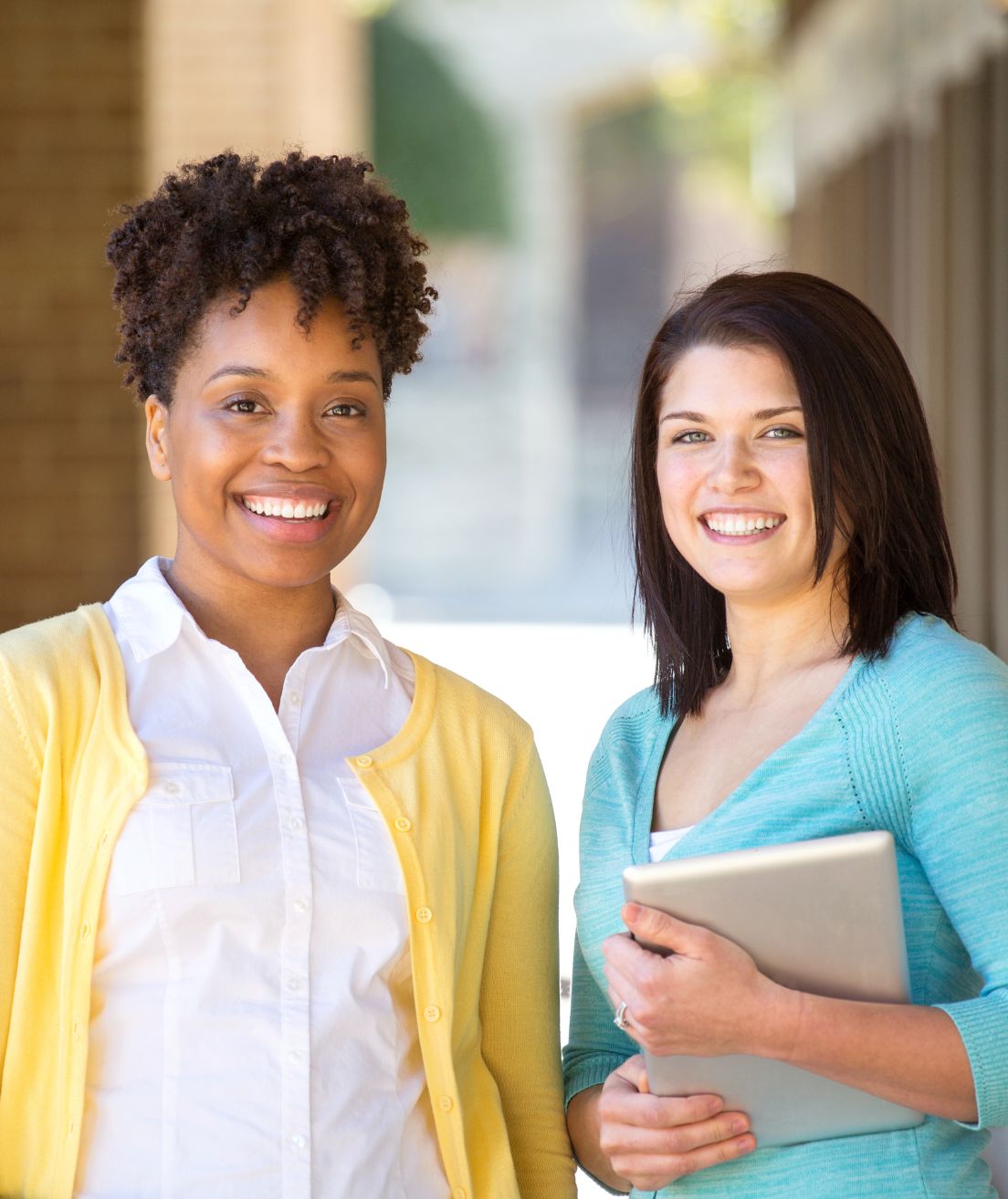 two women smiling outside image