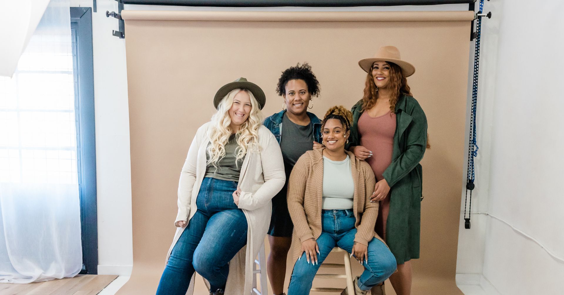 diverse group of women posing together at studio image